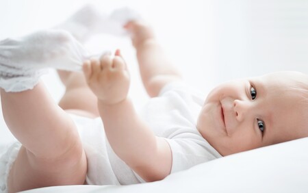 A baby grabbing their socks