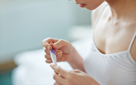 woman looking at pregnancy test