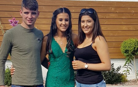 young man and two young women smiling for the camera