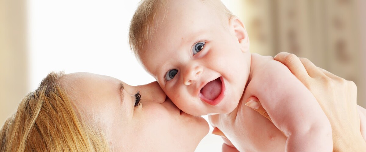 A mother kissing her baby
