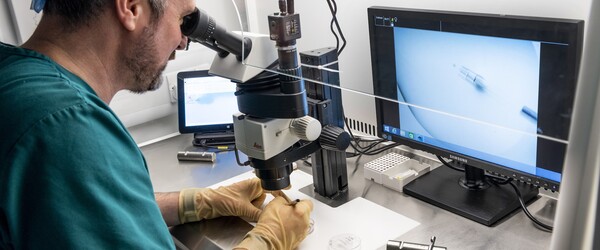 Scientist using a microscope