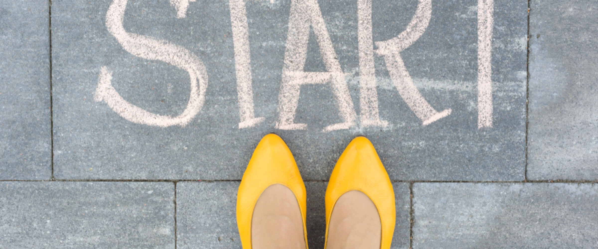 woman's feet beside the word start written on the ground