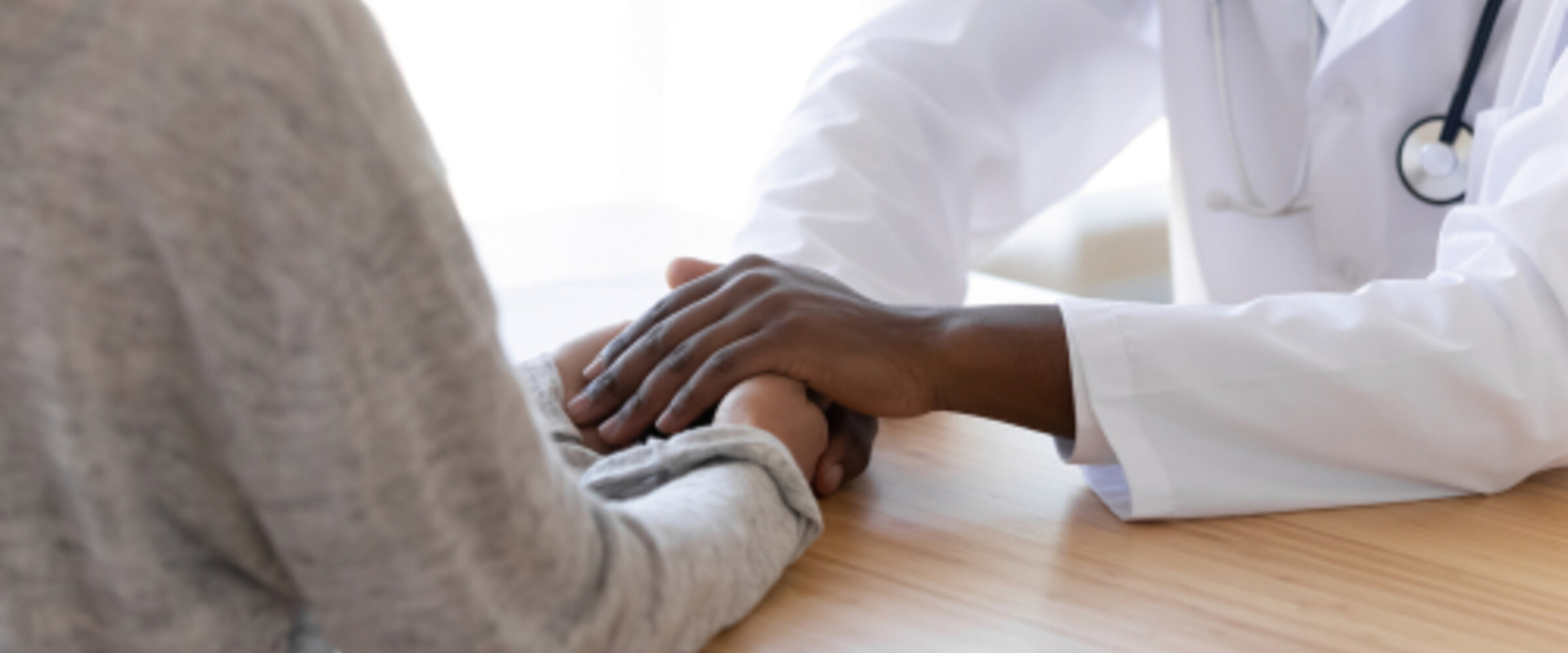 doctor holding a patients hand