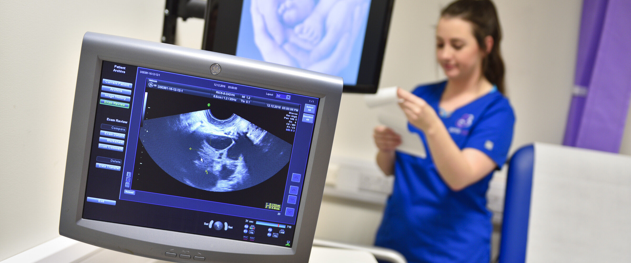 nurse taking notes during ultrasound scan