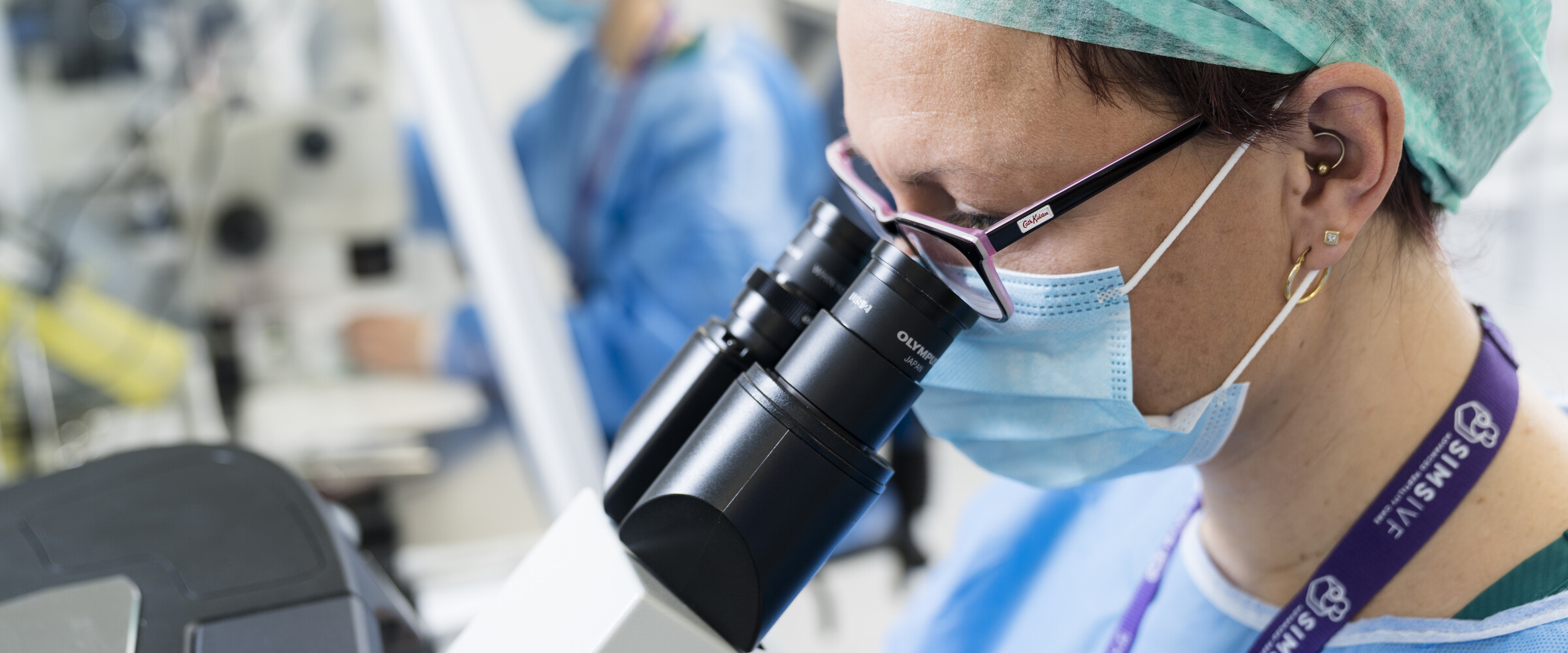scientist looking into microscope